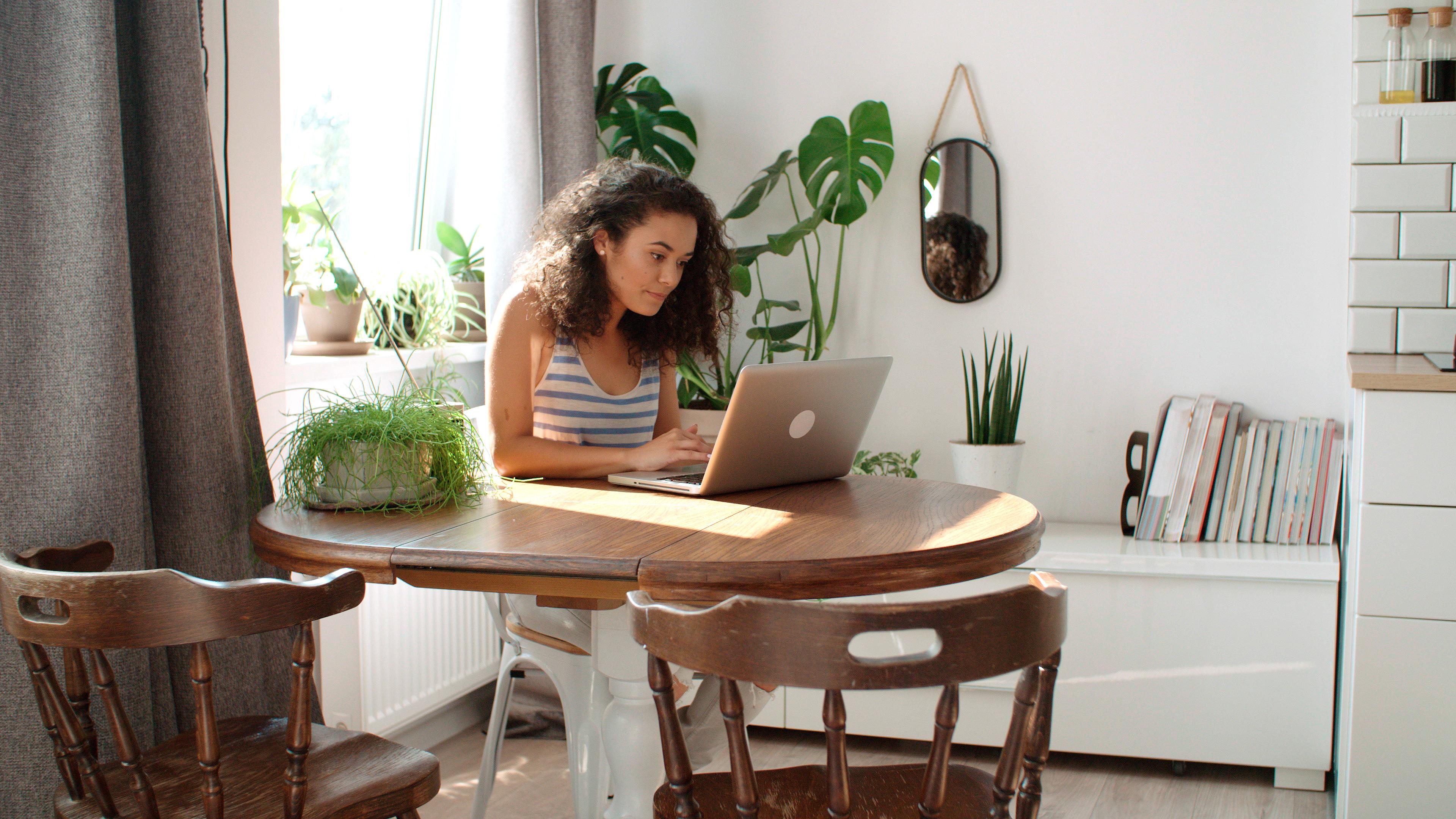 person working witj computer in a table